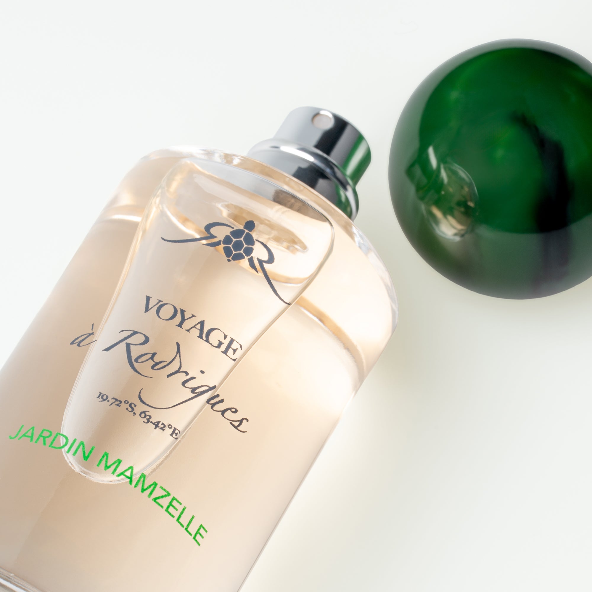 Perfume bottle labeled 'Voyage a Rodrigues' on a white background